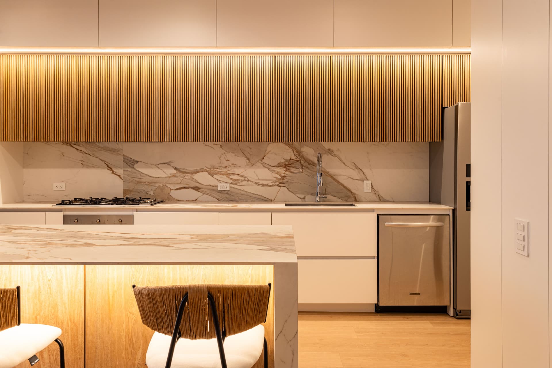 Regent's Park Villa — ribbed oak wall units with Calacatta marble island, London NW1