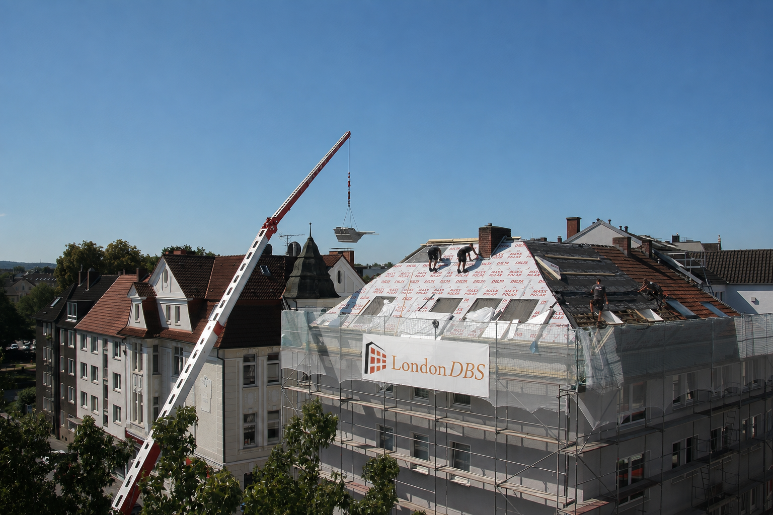 Central London external cladding and roofing works with crane and scaffold