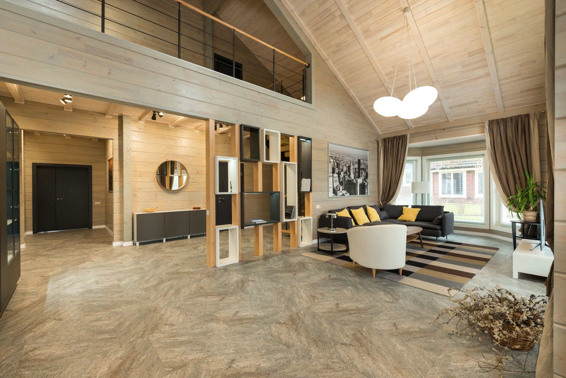 Vaulted living space with timber walls and large format stone flooring
