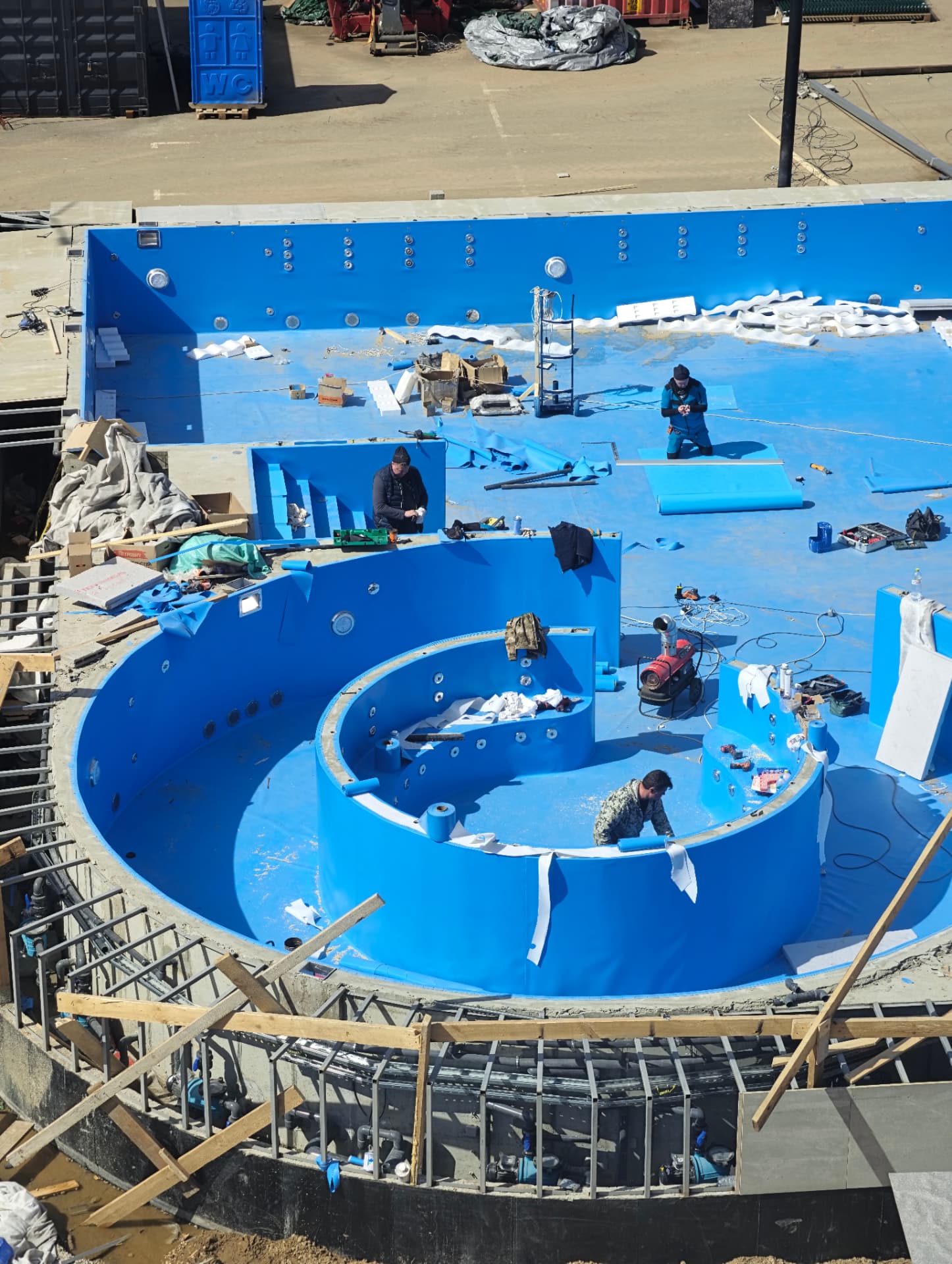 Pool tank and circular spa under construction with liner welding in progress