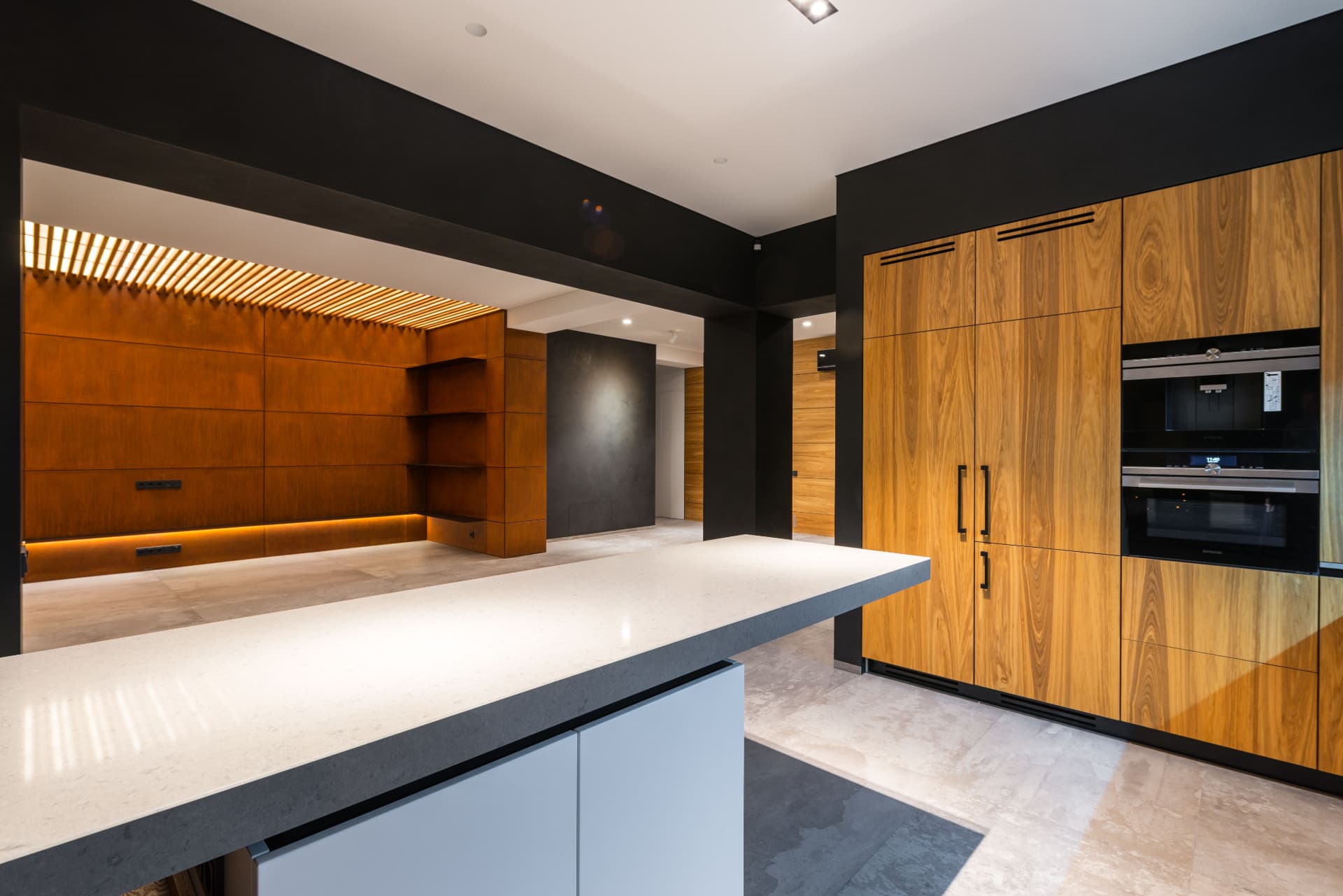 Belgravia Townhouse — walnut veneer kitchen with backlit slatted wall and stone island, London SW1