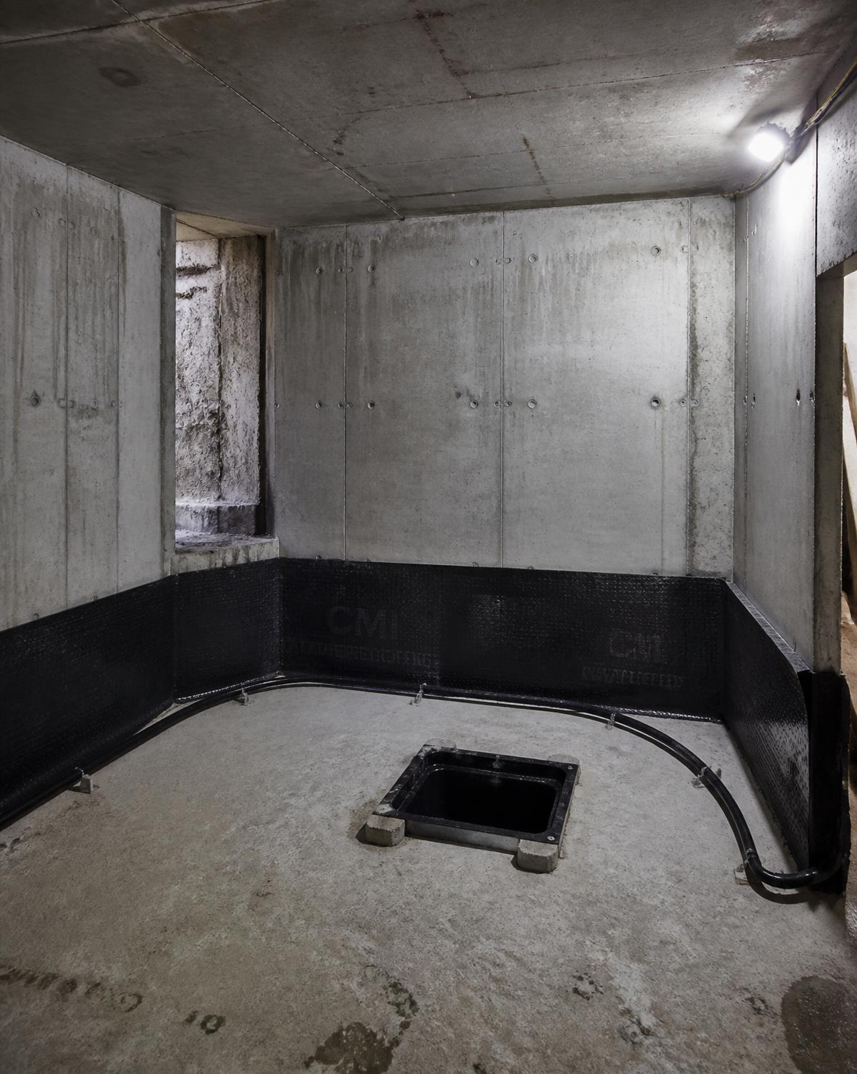 Completed reinforced concrete basement box with tanking membrane