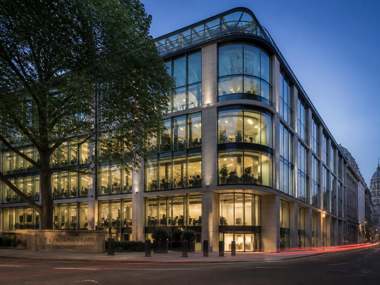 High-specification London office building lit at blue hour
