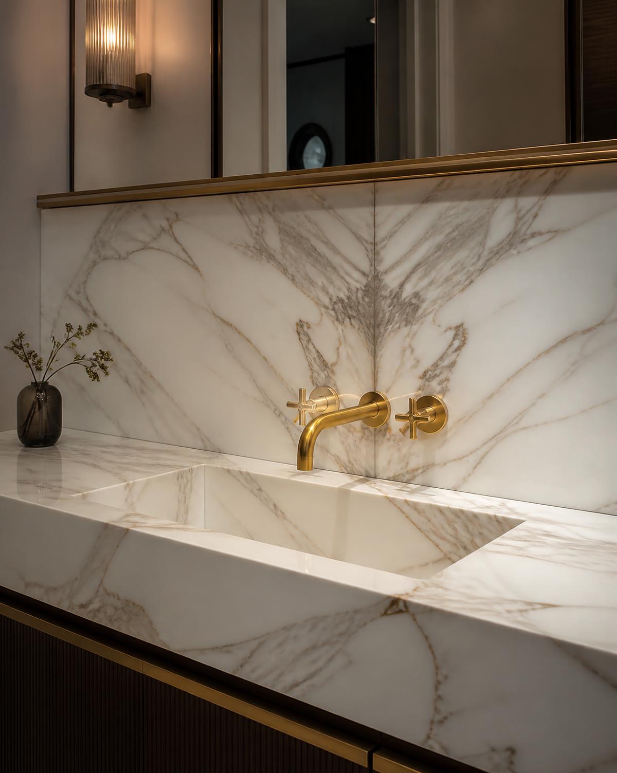Calacatta Gold vanity with integral basin and brass tap